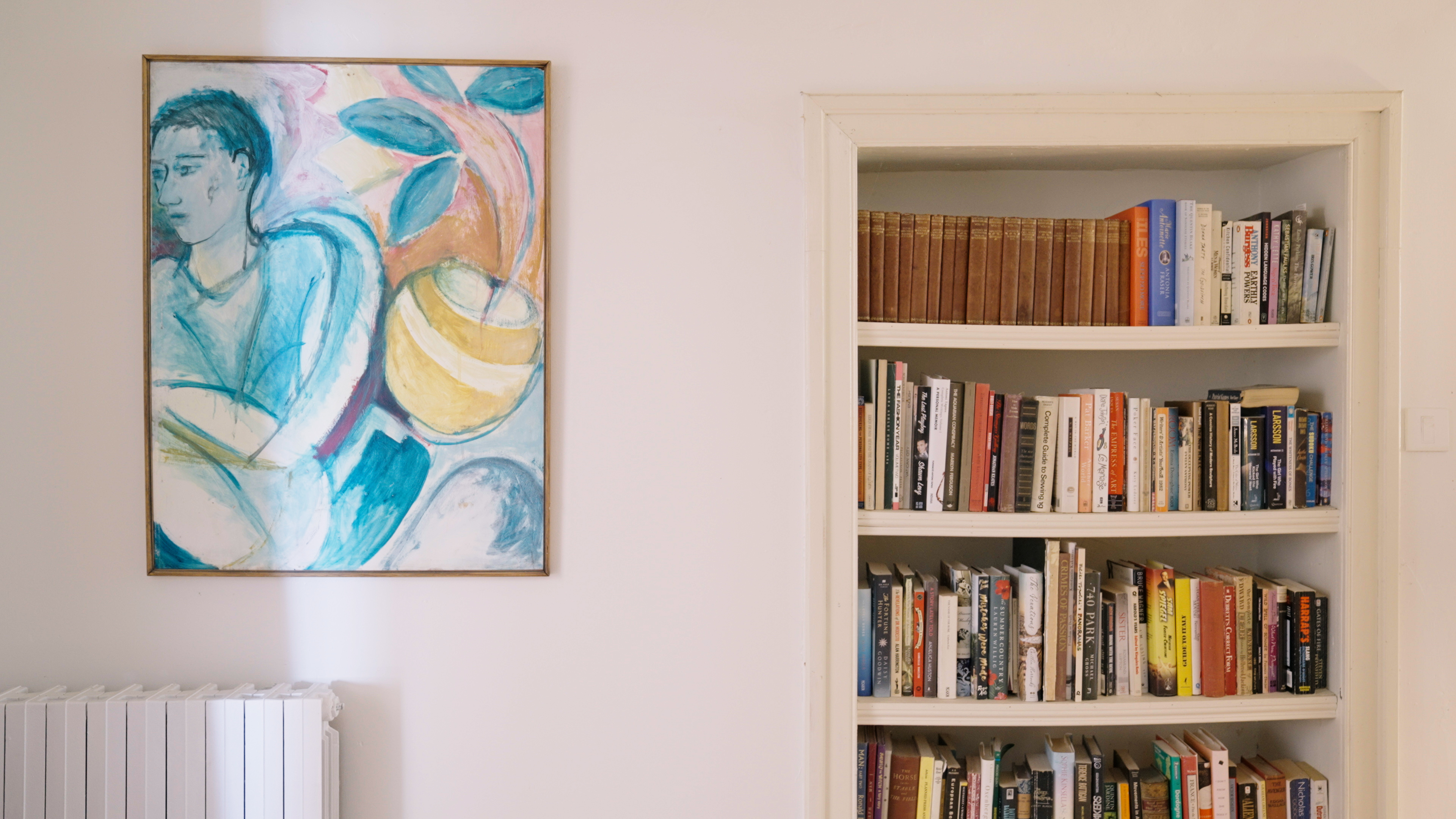 Styled living space with bookshelves and modern artwork